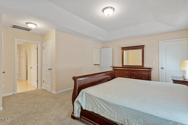 1213 Silver Beach Way, Raleigh, NC 27606 - bedroom with light carpet and a tray ceiling