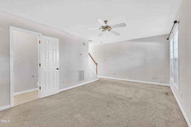 4825 Windbreak Ln, Raleigh, NC 27616 - carpeted empty room with a ceiling fan and stairs