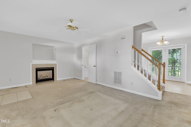 4825 Windbreak Ln, Raleigh, NC 27616 - unfurnished living room with stairs, a fireplace with flush hearth, a chandelier, and carpet floors