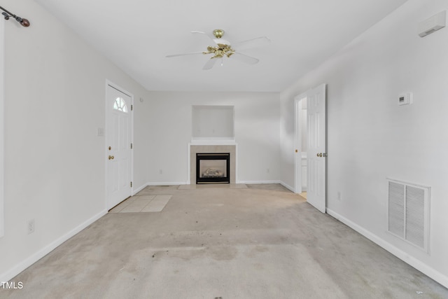4825 Windbreak Ln, Raleigh, NC 27616 - unfurnished living room featuring ceiling fan, a fireplace with flush hearth, and carpet floors