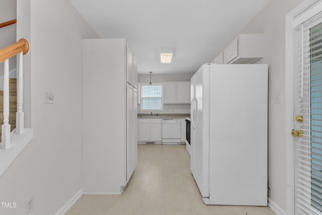 4825 Windbreak Ln, Raleigh, NC 27616 - kitchen with white appliances, white cabinetry, and light countertops