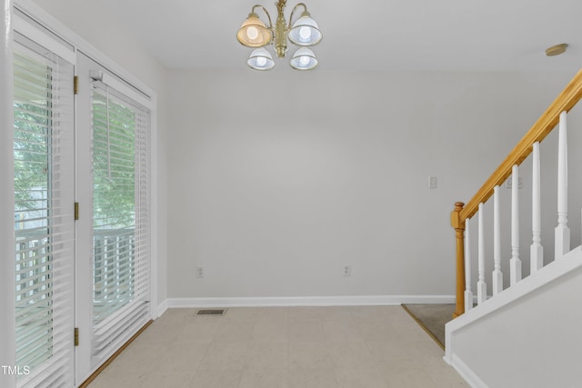 4825 Windbreak Ln, Raleigh, NC 27616 - empty room with a chandelier, stairway, and a smoke detector