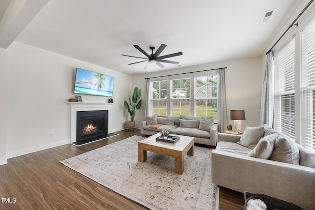 433 Village Bend Dr, Fuquay Varina, NC 27526 - living area featuring dark wood-style flooring, a lit fireplace, and ceiling fan