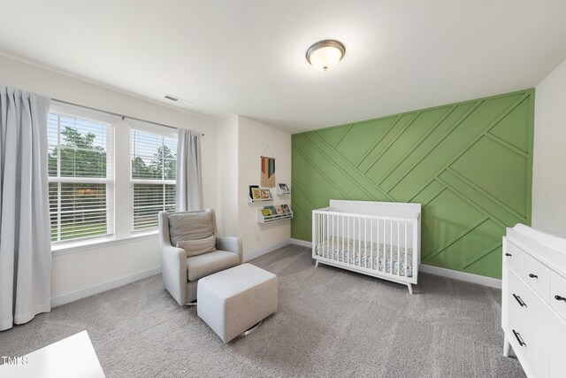 433 Village Bend Dr, Fuquay Varina, NC 27526 - bedroom featuring light carpet, an accent wall, and a crib