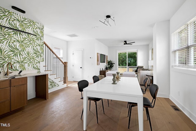 1410 Joe Louis Ave, Raleigh, NC 27610 - dining space with light wood finished floors, stairs, and a ceiling fan