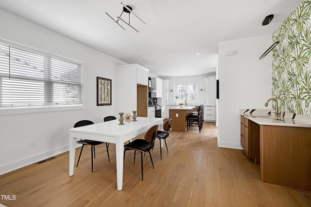 1410 Joe Louis Ave, Raleigh, NC 27610 - dining area with light wood-style flooring and baseboards