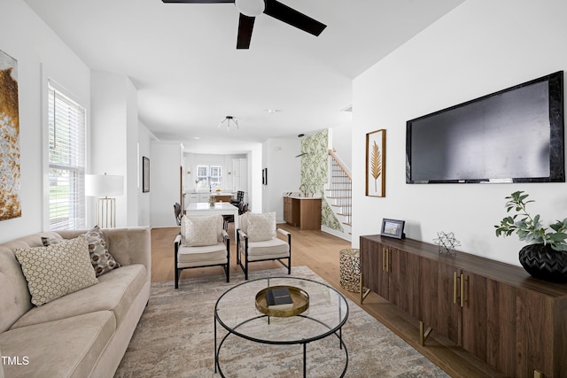 1410 Joe Louis Ave, Raleigh, NC 27610 - living area featuring stairway, light wood finished floors, and ceiling fan