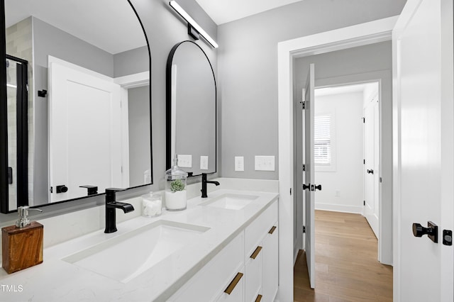 1410 Joe Louis Ave, Raleigh, NC 27610 - bathroom with double vanity, wood finished floors, and a stall shower