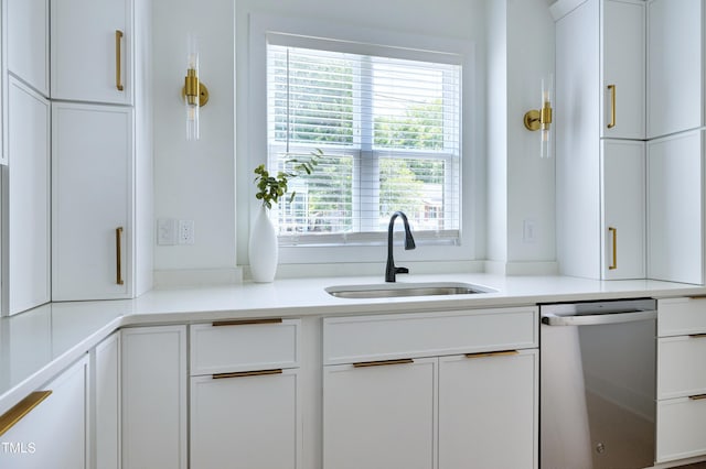 1410 Joe Louis Ave, Raleigh, NC 27610 - kitchen with dishwasher, white cabinetry, and light countertops