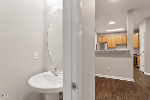 330 Gilman Ln Unit 109, Raleigh, NC 27610 - bathroom featuring wood finished floors and backsplash