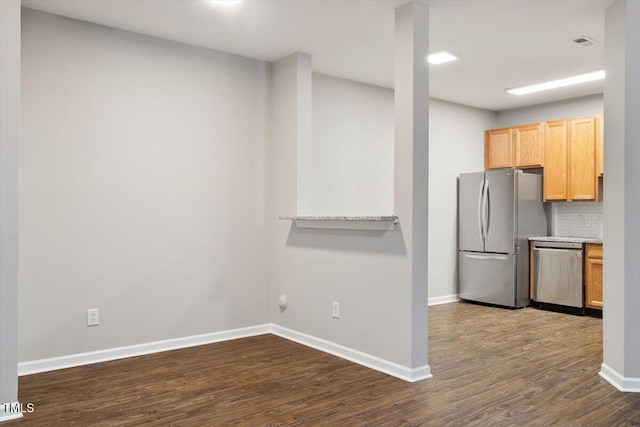 330 Gilman Ln Unit 109, Raleigh, NC 27610 - kitchen with stainless steel appliances, dark wood-type flooring, tasteful backsplash, light brown cabinetry, and light countertops