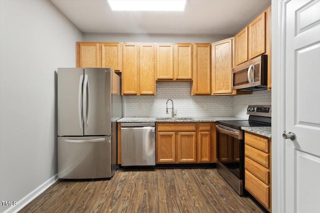 330 Gilman Ln Unit 109, Raleigh, NC 27610 - kitchen with appliances with stainless steel finishes, dark wood finished floors, tasteful backsplash, and light stone counters