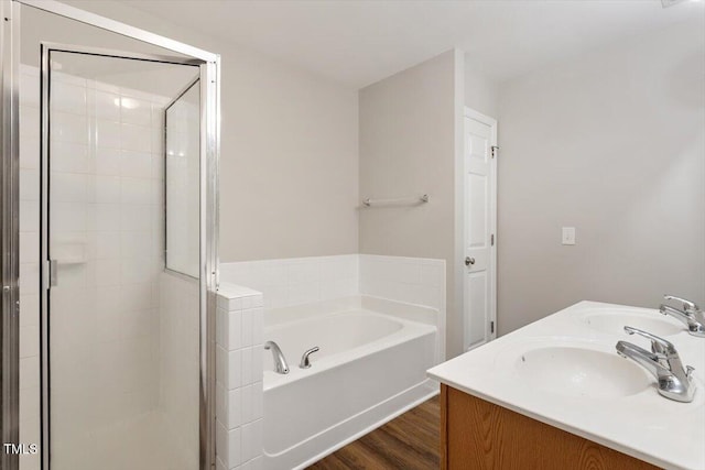 330 Gilman Ln Unit 109, Raleigh, NC 27610 - full bath featuring a garden tub, a shower stall, wood finished floors, and double vanity