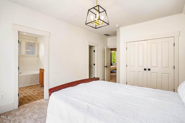 1168 Great Ridge Parkway, Chapel Hill, NC 27516 - carpeted bedroom with a closet, a chandelier, connected bathroom, and tile patterned flooring