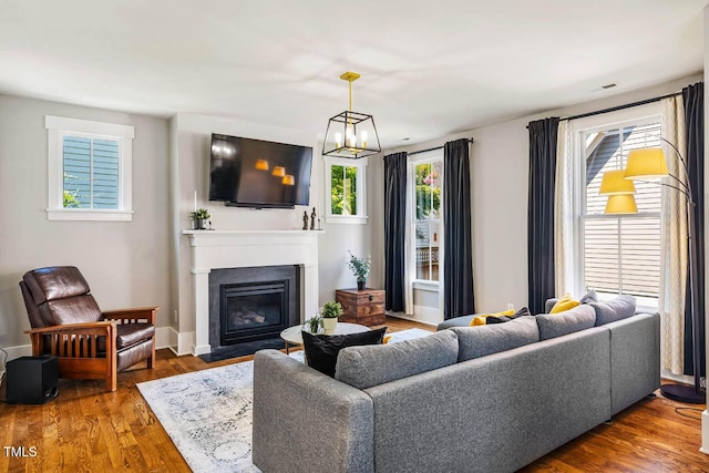 1168 Great Ridge Parkway, Chapel Hill, NC 27516 - living area with a fireplace with flush hearth, a chandelier, and wood finished floors