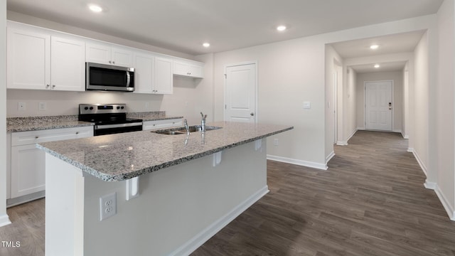 100 Grove Ln, Goldsboro, NC 27534 - kitchen featuring stainless steel appliances, white cabinets, dark wood-style flooring, an island with sink, and recessed lighting