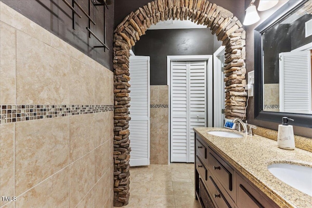 7856 Spungold St, Raleigh, NC 27617 - bathroom featuring double vanity and tile walls