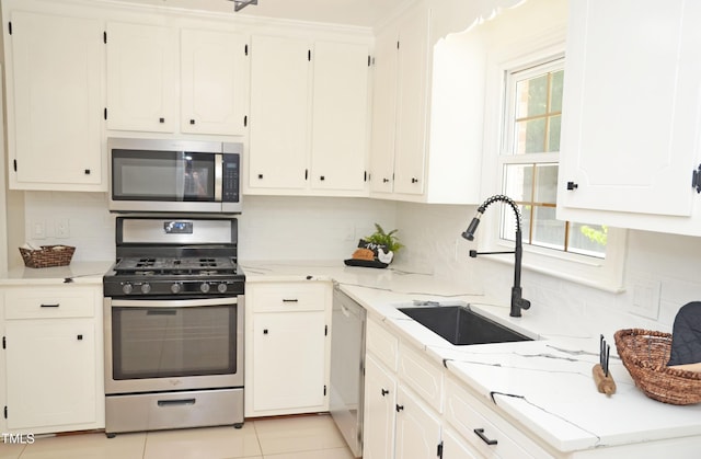 1815 Chandellay Dr, Durham, NC 27705 - kitchen with stainless steel appliances, white cabinets, and tasteful backsplash