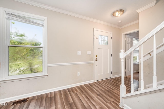 816 Kimpton Ct, Fuquay Varina, NC 27526 - foyer entrance with wood finished floors, crown molding, and stairway