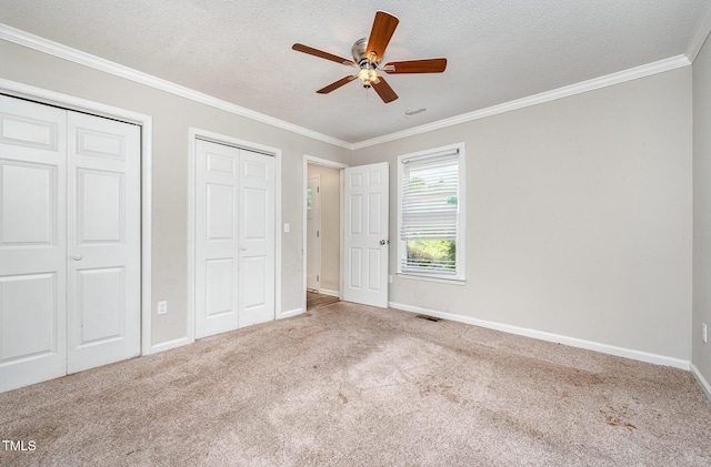 816 Kimpton Ct, Fuquay Varina, NC 27526 - unfurnished bedroom with carpet, two closets, crown molding, a textured ceiling, and ceiling fan