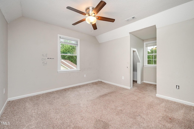 816 Kimpton Ct, Fuquay Varina, NC 27526 - unfurnished room featuring vaulted ceiling, ceiling fan, light colored carpet, plenty of natural light, and a textured ceiling