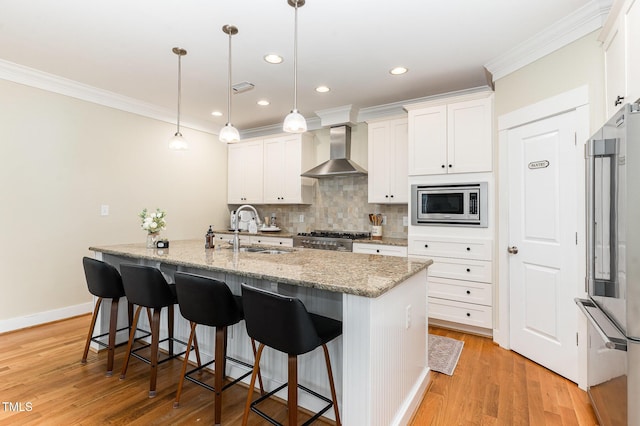 6 Tulip Tree Ct, Durham, NC 27712 - kitchen with wall chimney range hood, stainless steel microwave, refrigerator, crown molding, and decorative backsplash