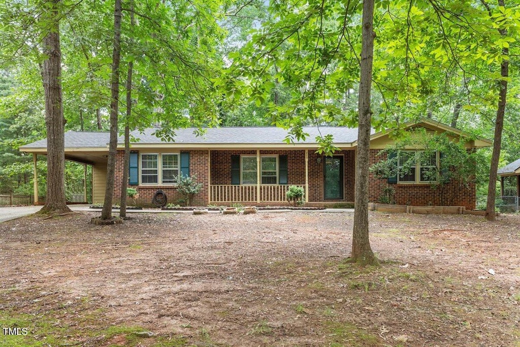 809 Valerie Dr, Raleigh, NC 27606 - ranch-style house with covered porch, a carport, brick siding, and concrete driveway