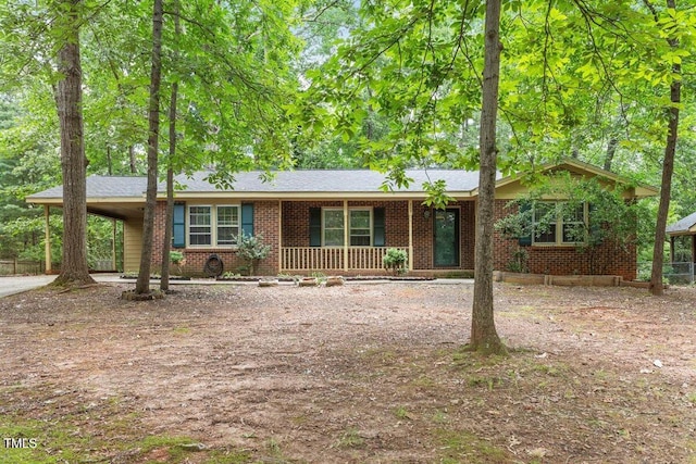 809 Valerie Dr, Raleigh, NC 27606 - ranch-style house with covered porch, a carport, brick siding, and concrete driveway