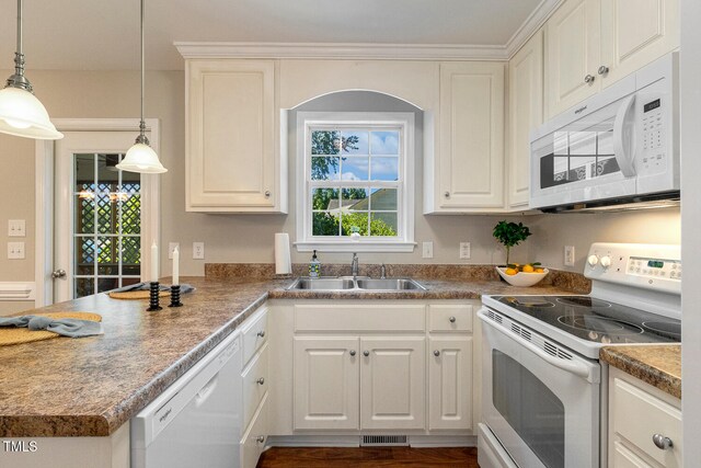 86 Basswood Cir, Willow Springs, NC 27592 - kitchen featuring white appliances, a peninsula, hanging light fixtures, and white cabinets