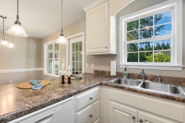 86 Basswood Cir, Willow Springs, NC 27592 - kitchen with healthy amount of natural light, dishwasher, hanging light fixtures, and white cabinetry