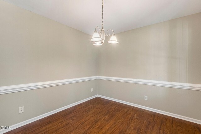 86 Basswood Cir, Willow Springs, NC 27592 - empty room with dark wood-style floors and a chandelier