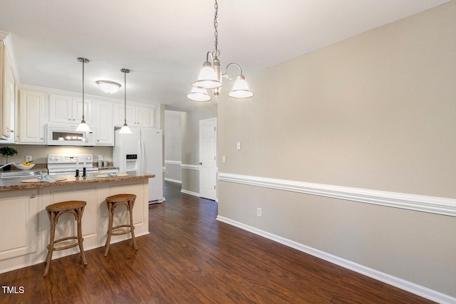86 Basswood Cir, Willow Springs, NC 27592 - kitchen featuring white appliances, dark wood-type flooring, a peninsula, and white cabinets
