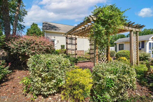 86 Basswood Cir, Willow Springs, NC 27592 - view of front facade featuring a pergola and roof with shingles