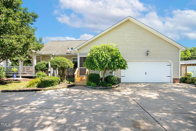 86 Basswood Cir, Willow Springs, NC 27592 - view of front of house featuring driveway, an attached garage, brick siding, and roof with shingles