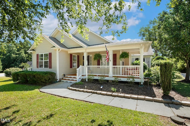 86 Basswood Cir, Willow Springs, NC 27592 - view of front of home with covered porch and a front yard