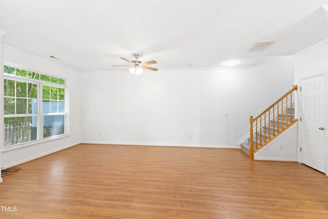 11710 Mezzanine Dr Unit 101, Raleigh, NC 27614 - unfurnished living room with crown molding, a ceiling fan, light wood finished floors, and stairway