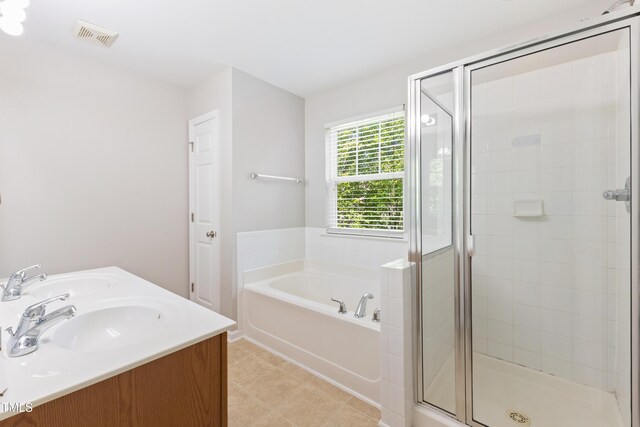 11710 Mezzanine Dr Unit 101, Raleigh, NC 27614 - full bathroom with a garden tub, a stall shower, double vanity, and tile patterned flooring