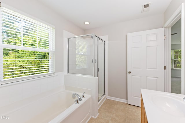 11710 Mezzanine Dr Unit 101, Raleigh, NC 27614 - bathroom with a bath, plenty of natural light, a shower stall, tile patterned floors, and recessed lighting