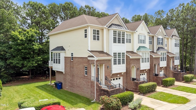 5503 Silver Moon Ln, Raleigh, NC 27606 - view of front of property with a garage, brick siding, a front yard, and a shingled roof