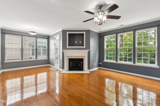5503 Silver Moon Ln, Raleigh, NC 27606 - unfurnished living room with ornamental molding, ceiling fan, wood finished floors, and a fireplace