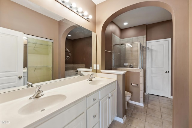 5503 Silver Moon Ln, Raleigh, NC 27606 - full bath with double vanity, a shower stall, tile patterned flooring, and a spacious closet