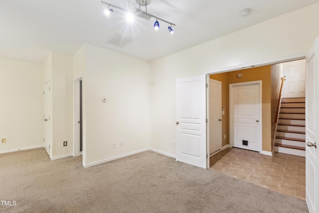 5503 Silver Moon Ln, Raleigh, NC 27606 - unfurnished room with light colored carpet, a smoke detector, stairs, and rail lighting