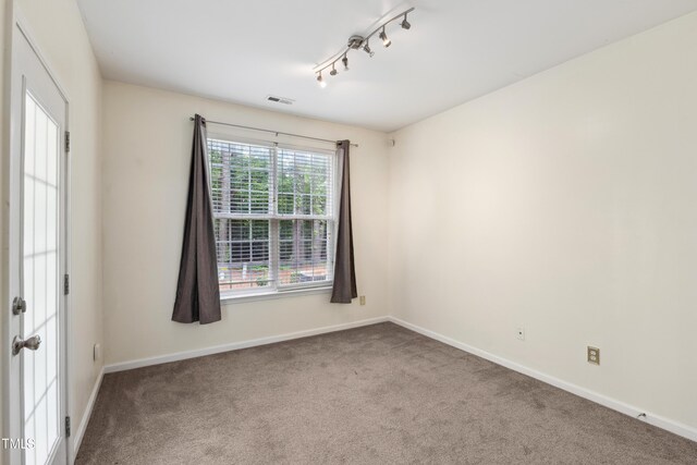 5503 Silver Moon Ln, Raleigh, NC 27606 - empty room with carpet flooring and rail lighting
