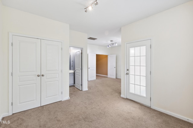 5503 Silver Moon Ln, Raleigh, NC 27606 - unfurnished bedroom with track lighting, carpet floors, and a closet