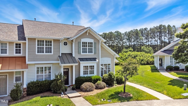 15 Canary Ct, Durham, NC 27713 - view of front facade featuring a standing seam roof, a shingled roof, a front lawn, and a metal roof