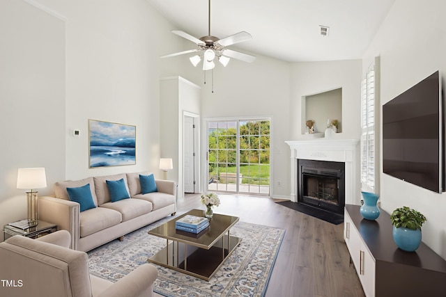 15 Canary Ct, Durham, NC 27713 - living area featuring a ceiling fan, wood finished floors, a fireplace with flush hearth, and high vaulted ceiling