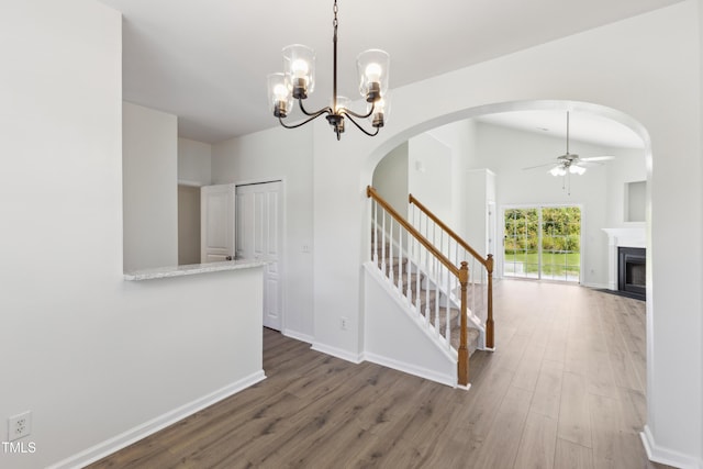 15 Canary Ct, Durham, NC 27713 - staircase with ceiling fan, wood finished floors, a fireplace, and arched walkways