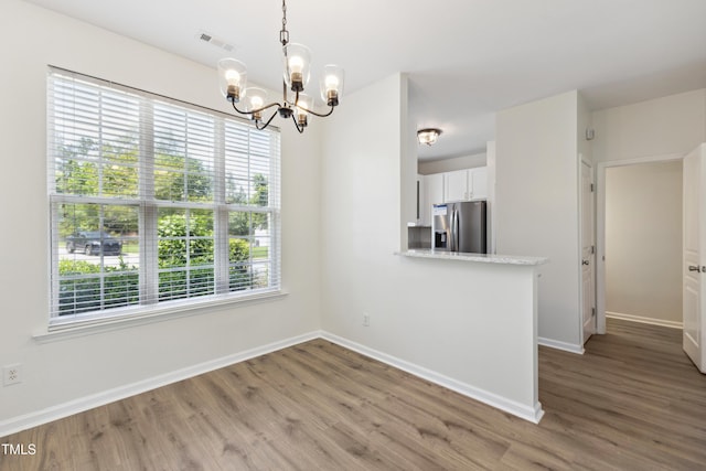 15 Canary Ct, Durham, NC 27713 - unfurnished dining area featuring a chandelier and wood finished floors