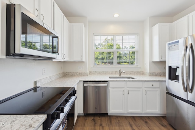 15 Canary Ct, Durham, NC 27713 - kitchen with appliances with stainless steel finishes, white cabinetry, recessed lighting, and light stone counters