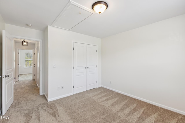 15 Canary Ct, Durham, NC 27713 - unfurnished bedroom featuring attic access, light carpet, and a closet